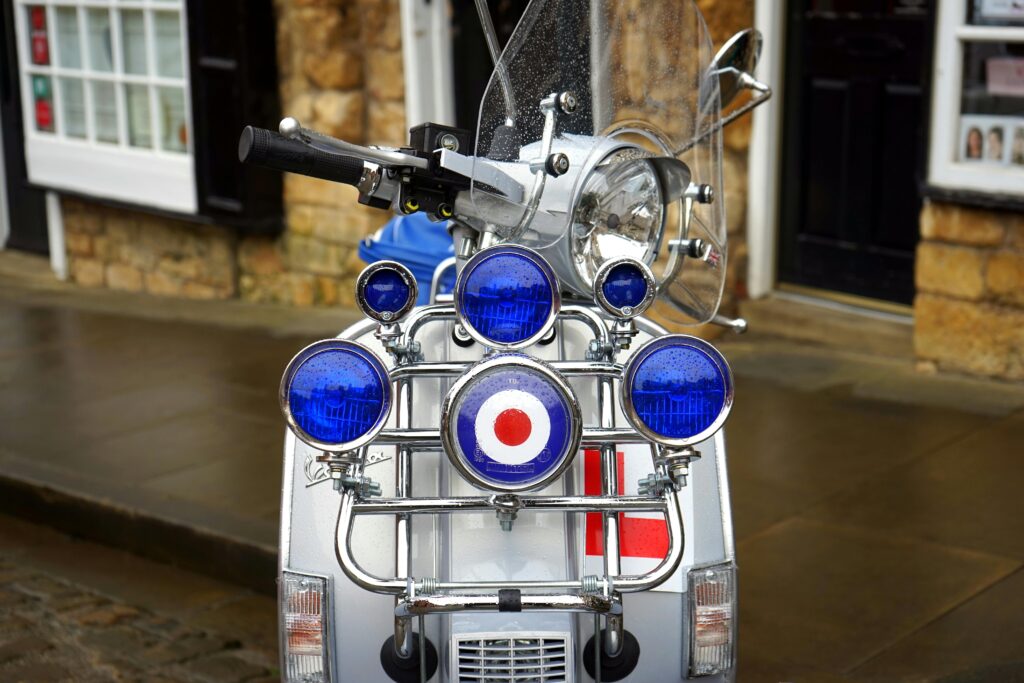 Front view of a classic Vespa scooter with iconic Mod target design and multiple mirrors.