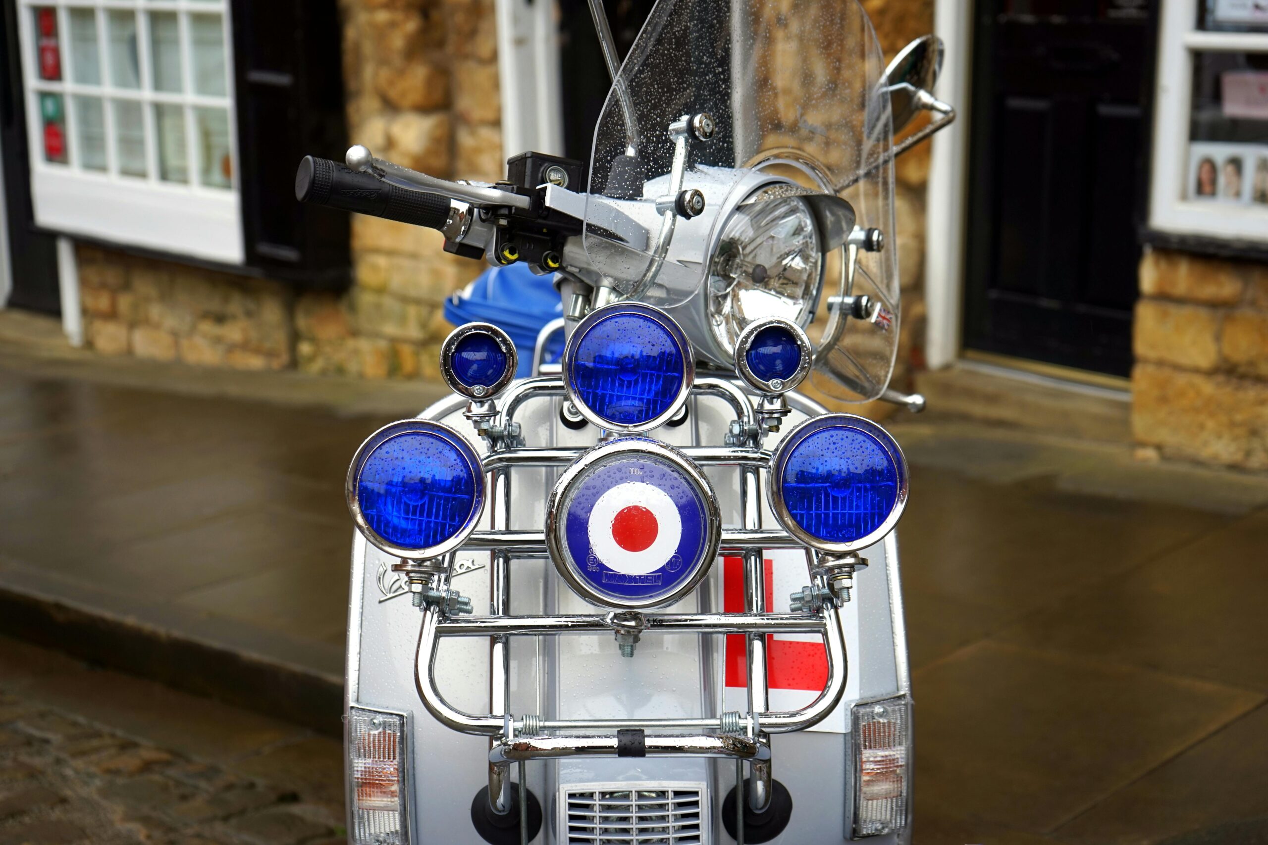 Front view of a classic Vespa scooter with iconic Mod target design and multiple mirrors.