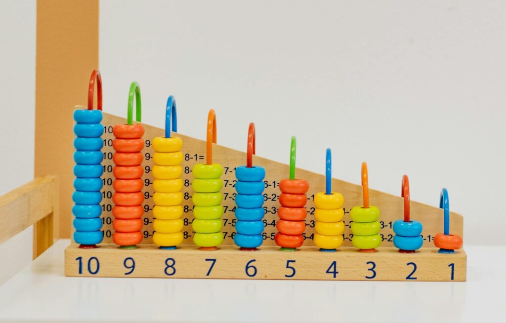 Close-up of a colorful wooden counting toy with numbers and shapes, perfect for preschool learning.